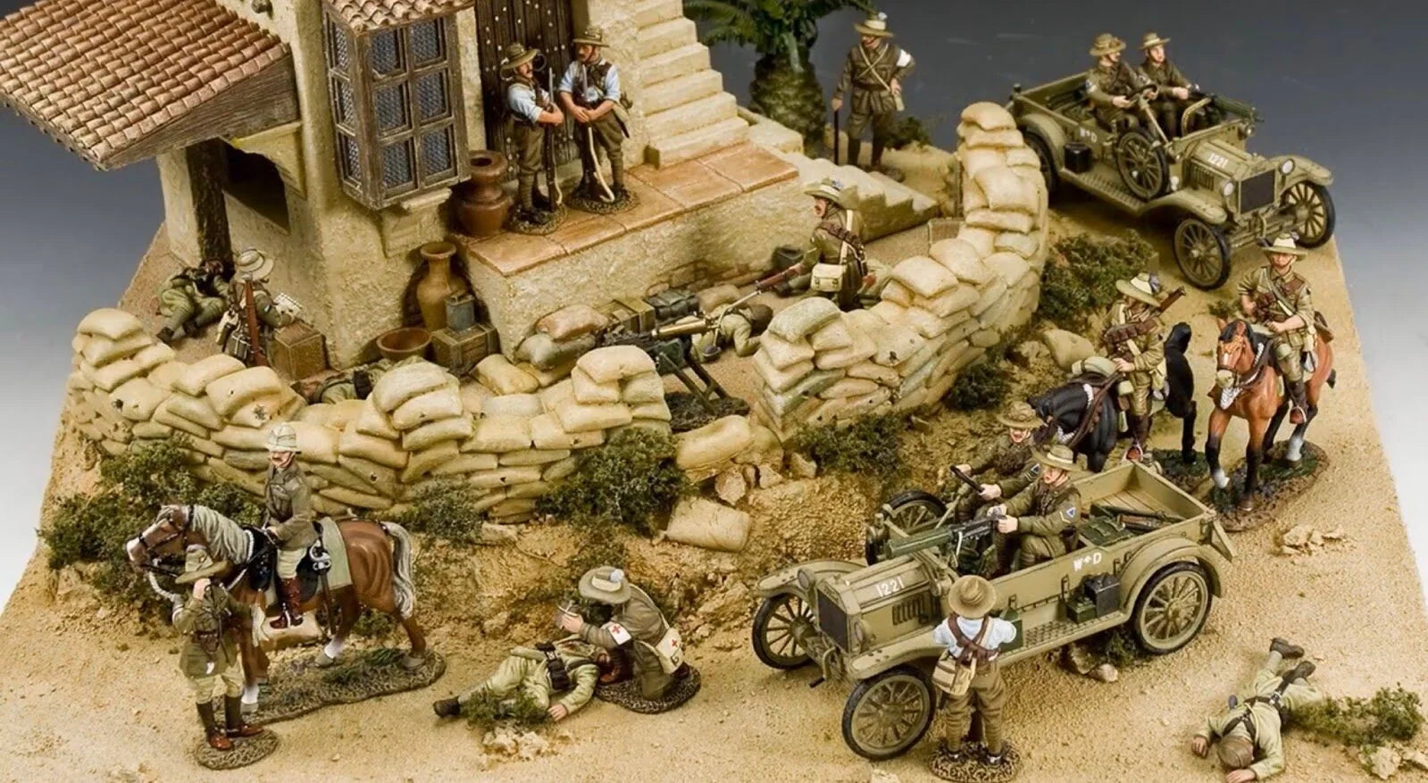 A military miniature diorama with soldiers, motorcycles and a village scene